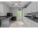 This laundry room features storage cabinets, washer and dryer, and natural lighting at 12537 Birchfalls Dr, Raleigh, NC 27614