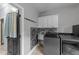 Practical laundry area with designer backsplash, modern fixtures and appliances at 12537 Birchfalls Dr, Raleigh, NC 27614