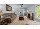 A cozy living room with a fireplace, a brown sofa, and modern flooring at 12537 Birchfalls Dr, Raleigh, NC 27614