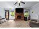A large, bright living room highlights a beautiful brick fireplace and new laminate flooring at 12537 Birchfalls Dr, Raleigh, NC 27614