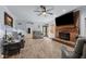 Expansive living room features a brick fireplace and views to the outdoors at 12537 Birchfalls Dr, Raleigh, NC 27614