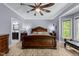 Spacious main bedroom with a ceiling fan, wood-look floors, and bright natural light at 12537 Birchfalls Dr, Raleigh, NC 27614