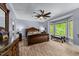 Spacious main bedroom with a bay window, ceiling fan, and detailed wood furniture at 12537 Birchfalls Dr, Raleigh, NC 27614