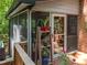 View of a screened porch with a door and wood railings at 12537 Birchfalls Dr, Raleigh, NC 27614