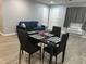 Dining area with black chairs and table setting, a grey sofa and a white door at 130 S Estes Dr # C-5, Chapel Hill, NC 27514