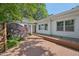 This charming home boasts a spacious wooden deck and inviting backyard with lush greenery and mature trees at 1316 Glenwood Ave, Raleigh, NC 27605