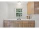 Bright kitchen with white countertops, light wooden cabinets and a stainless steel sink at 1316 Glenwood Ave, Raleigh, NC 27605
