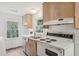 Galley kitchen featuring light wood cabinets, white countertops, modern flooring and stainless steel sink at 1316 Glenwood Ave, Raleigh, NC 27605