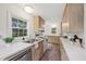 Bright kitchen with white countertops, wooden cabinets, stainless steel sink and updated appliances at 1316 Glenwood Ave, Raleigh, NC 27605