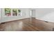 Well-lit living room with hardwood floors and large windows offering a view of the outside at 1316 Glenwood Ave, Raleigh, NC 27605