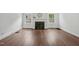 Inviting living room featuring a cozy fireplace, hardwood floors, and abundant natural light from large windows at 1316 Glenwood Ave, Raleigh, NC 27605