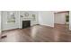 Bright living room featuring a classic fireplace, hardwood floors, and ample natural light from large windows at 1316 Glenwood Ave, Raleigh, NC 27605