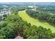 Aerial view of picturesque golf course neighborhood surrounded by lush greenery and pristine lawns at 1501 Samuel Wait Ln, Wake Forest, NC 27587