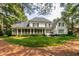 Expansive backyard features a well-manicured lawn, patio and screened in porch, perfect for outdoor entertaining at 1501 Samuel Wait Ln, Wake Forest, NC 27587