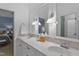 Elegant bathroom featuring dual sinks, marble countertops, and white cabinetry with a view to the bedroom at 1501 Samuel Wait Ln, Wake Forest, NC 27587