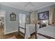 Comfortable bedroom with wood floors, light blue walls, and natural light at 1501 Samuel Wait Ln, Wake Forest, NC 27587