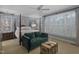 This bedroom boasts a four-poster bed, sitting area, plantation shutters, and plenty of natural light at 1501 Samuel Wait Ln, Wake Forest, NC 27587