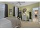 Bright bedroom with shuttered windows, a white bed frame, and a view into the ensuite bathroom at 1501 Samuel Wait Ln, Wake Forest, NC 27587