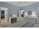 Bright bedroom with a modern desk, a view to an adjacent room, and plush carpeted flooring at 1501 Samuel Wait Ln, Wake Forest, NC 27587