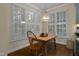 Bright dining area features large windows, shutter blinds, and hardwood floors at 1501 Samuel Wait Ln, Wake Forest, NC 27587