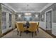 Formal dining room with stylish lighting and a table set for elegant dinners at 1501 Samuel Wait Ln, Wake Forest, NC 27587