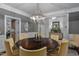 Elegant dining room features a wood table, chandelier, and access to other rooms, perfect for entertaining guests at 1501 Samuel Wait Ln, Wake Forest, NC 27587