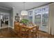 Bright dining area with ample natural light, stylish decor, and hardwood floors at 1501 Samuel Wait Ln, Wake Forest, NC 27587