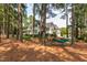 Gorgeous two-story home with pristine landscaping, mature trees, outdoor seating and a hammock for backyard relaxation at 1501 Samuel Wait Ln, Wake Forest, NC 27587