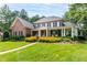 Elegant brick home boasts a sprawling lawn and charming covered porch at 1501 Samuel Wait Ln, Wake Forest, NC 27587
