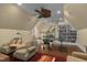 Spacious game room featuring a ping pong table, cozy armchairs, and a custom built-in bookshelf for entertainment at 1501 Samuel Wait Ln, Wake Forest, NC 27587