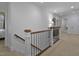 Bright hallway features neutral carpeting, white walls and trim, and a staircase with dark wood and black metal railing at 1501 Samuel Wait Ln, Wake Forest, NC 27587