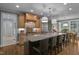 Open-concept kitchen with granite countertops, stainless steel appliances, ample counter space, and a breakfast bar at 1501 Samuel Wait Ln, Wake Forest, NC 27587