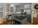 Charming kitchen features an island with seating, stainless steel appliances, and hardwood floors at 1501 Samuel Wait Ln, Wake Forest, NC 27587
