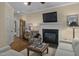 Cozy living room featuring a fireplace, hardwood floors, and comfortable seating, perfect for relaxation and entertaining at 1501 Samuel Wait Ln, Wake Forest, NC 27587