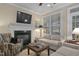 Comfortable living room features a fireplace and large windows offering ample natural light at 1501 Samuel Wait Ln, Wake Forest, NC 27587