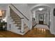 Elegant staircase with hardwood floors leads to the upper level of the home at 1501 Samuel Wait Ln, Wake Forest, NC 27587