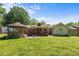 Spacious backyard featuring a gazebo, patio with a fire pit, and well-maintained lawn at 1612 Regency Dr, Burlington, NC 27215
