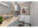 Cozy bathroom featuring a sink vanity, toilet, and shower with a decorative curtain at 1612 Regency Dr, Burlington, NC 27215