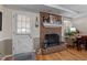 Cozy brick fireplace with decorative accents and adjacent study area at 1612 Regency Dr, Burlington, NC 27215