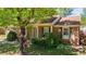Welcoming entrance of a brick home, showcasing detailed trim and a lush, green lawn at 1612 Regency Dr, Burlington, NC 27215