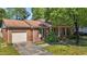 Well-maintained brick home featuring an attached garage and manicured front yard at 1612 Regency Dr, Burlington, NC 27215