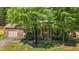 Charming brick home with attached garage, tidy landscaping, and a cozy front porch at 1612 Regency Dr, Burlington, NC 27215