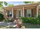 Close-up of the front porch featuring brick columns, decorative shutters, and a welcoming entrance at 1612 Regency Dr, Burlington, NC 27215