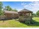 Backyard gazebo next to a brick home provides an outdoor retreat, set in a well-maintained grassy area at 1612 Regency Dr, Burlington, NC 27215