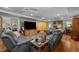 Spacious living room featuring comfortable seating, a large TV, and hardwood floors at 1612 Regency Dr, Burlington, NC 27215