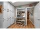 Charming pantry area boasts ample white cabinetry, open shelving, and hardwood floors at 1612 Regency Dr, Burlington, NC 27215