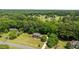 Overhead view of brick home nestled amongst lush trees with a well-manicured lawn at 170 Homestead Rd, Angier, NC 27501