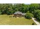 Aerial view of a well-maintained brick home set on a large, wooded lot at 170 Homestead Rd, Angier, NC 27501