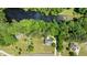 Aerial view of a brick home near a river and bordered by lush trees and woods at 170 Homestead Rd, Angier, NC 27501