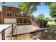 Expansive two-level back deck with covered space, attached to a brick home and fenced yard at 170 Homestead Rd, Angier, NC 27501